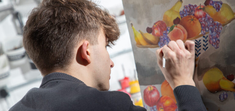 A Level Fine Art student painting in art studio