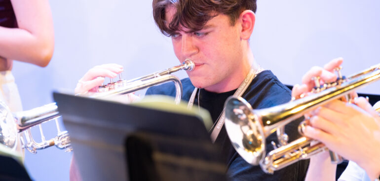 A Level Music student in the choir playing trumpet
