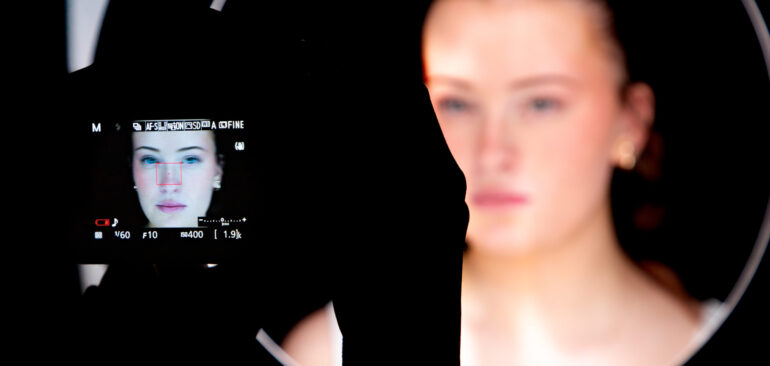 A Level Photography student taking a photo in the studio