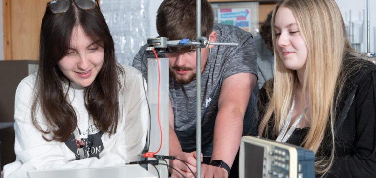 A Level Physics students working on equipment in science lab