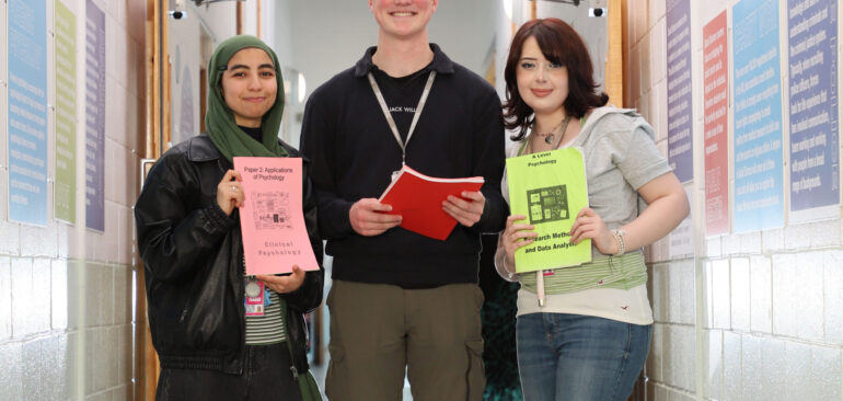 A Level Psychology students standing in Grizedale with workbooks