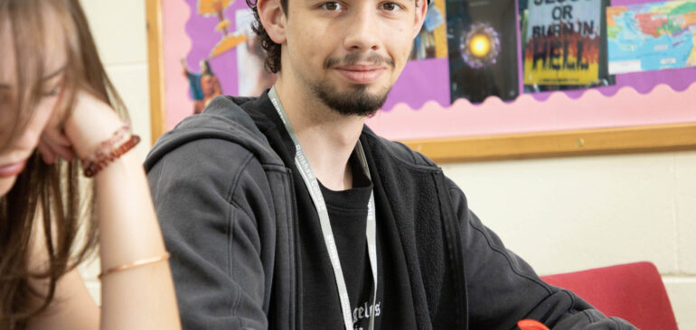 A Level Religious Studies student sitting at desk