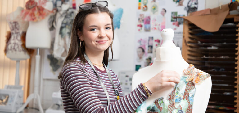 A Level Textiles student dressing a mannequin