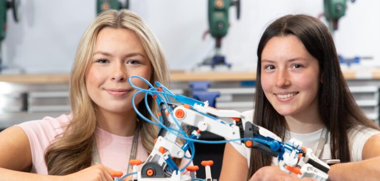 Level 3 Engineering students with model robot in engineering workshop in Buttermere