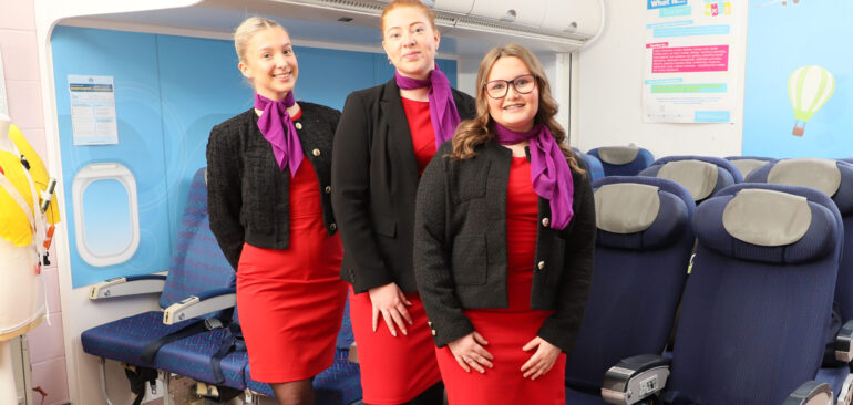 Level 3 Tourism Management with Cabin Crew three students in aeroplane set