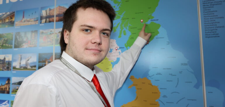 Level 1 Events, Customer Service & Tourism student in front of map in Dalehead