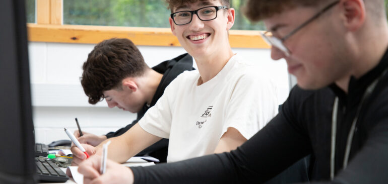T Level Business Management & Leadership student working at a computer desk