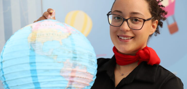 Level 2 Travel, Tourism & Visitor Economy student holding up globe in class