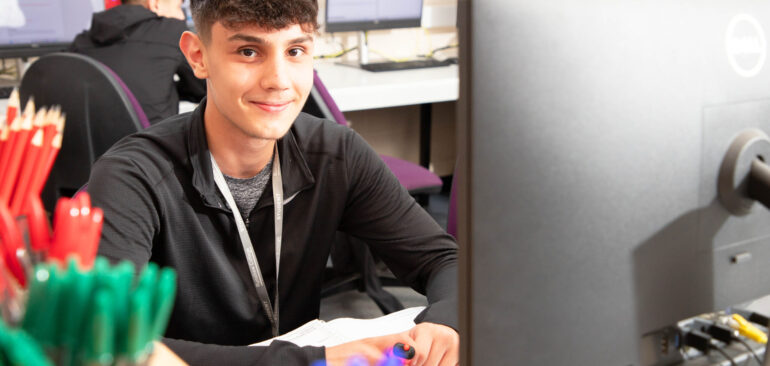 Level 2 Business student working at computer desk